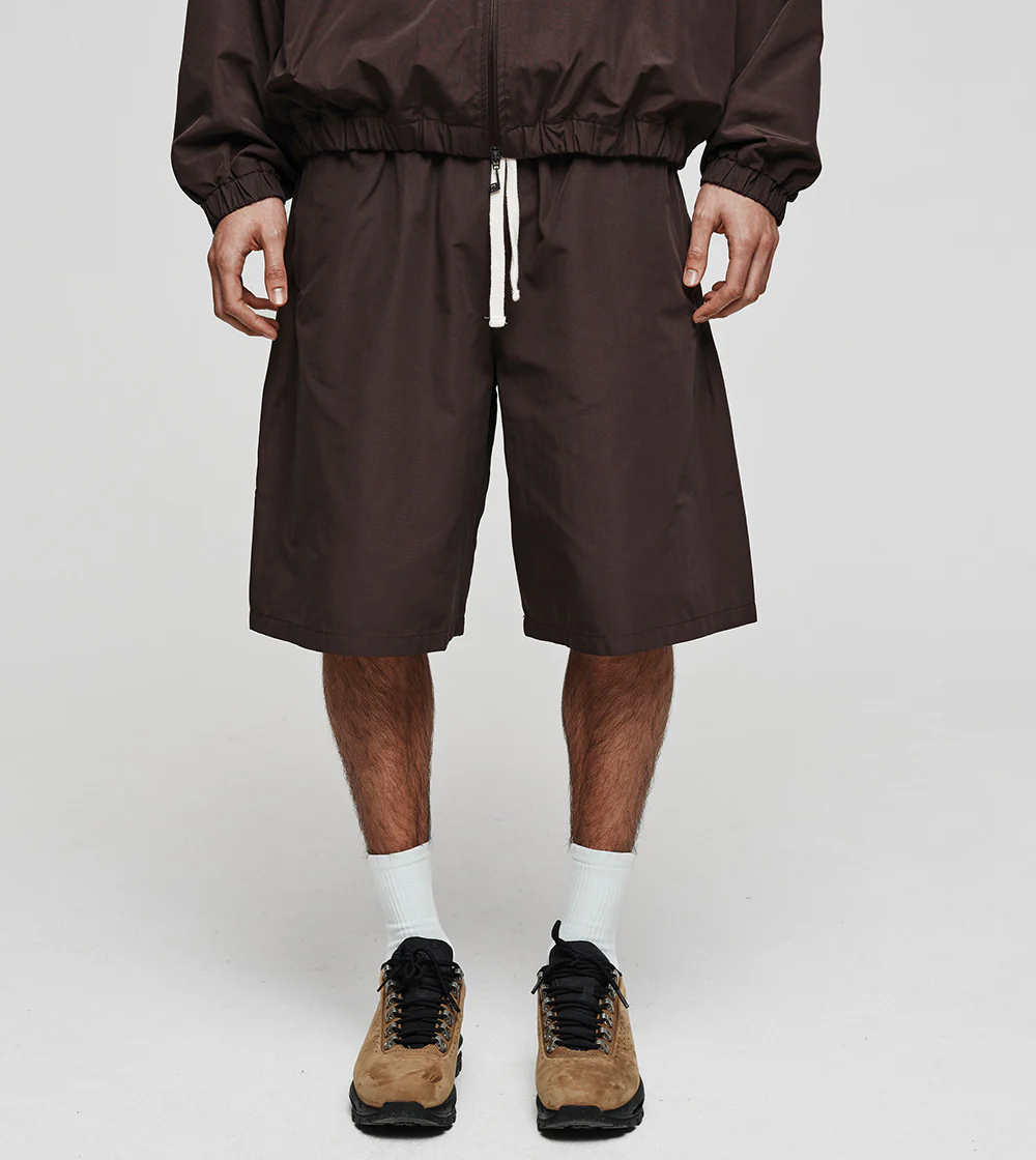 Top 10 streetwear brands 2026 - flat lay of iconic streetwear pieces including hoodies, cargo pants and sneakers